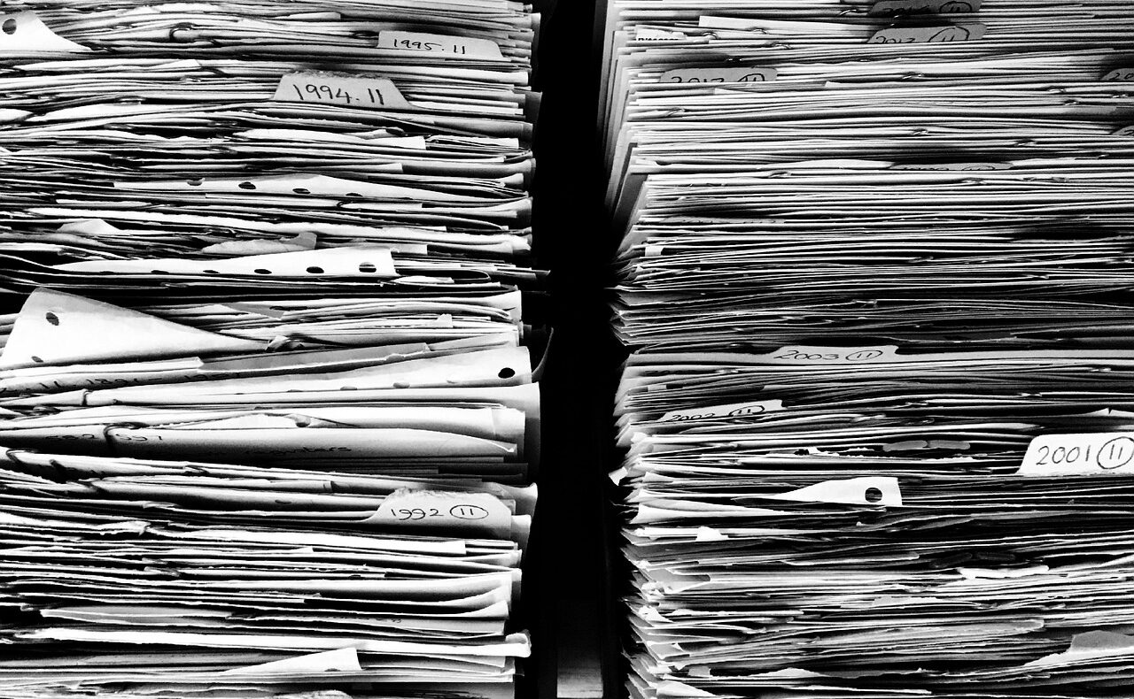 Ein Stapel Insolvenzakten auf einem Schreibtisch symbolisiert die steigenden Firmeninsolvenzen in Österreich – Foto: myrfa / Pixabay